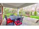 Covered patio with outdoor dining set, stone floor and view of the yard at 7756 N Audubon Rd, Indianapolis, IN 46250