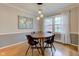Dining room features wood floors and table, modern lighting, and stylish decor for everyday elegance at 7756 N Audubon Rd, Indianapolis, IN 46250