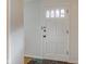 Bright entryway features a white door with glass panes and stylish multi-colored tile flooring at 7756 N Audubon Rd, Indianapolis, IN 46250