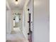Bright hallway with neutral carpet, white walls, and multiple doorways leading to other rooms at 7756 N Audubon Rd, Indianapolis, IN 46250