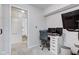 Home office setup with modern desk, multiple monitors, and a decorative brick wall accent at 7756 N Audubon Rd, Indianapolis, IN 46250