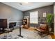 Inviting home office with a modern desk, comfortable seating, and natural light creating a productive workspace at 7756 N Audubon Rd, Indianapolis, IN 46250
