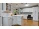 Elegant kitchen with white cabinetry, breakfast bar, and open layout to adjoining living spaces at 7756 N Audubon Rd, Indianapolis, IN 46250