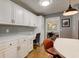 Bright kitchen featuring white cabinetry, built-in desk, and modern finishes for a functional space at 7756 N Audubon Rd, Indianapolis, IN 46250