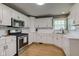 Beautifully designed kitchen with modern appliances, white cabinets, and updated fixtures at 7756 N Audubon Rd, Indianapolis, IN 46250