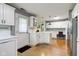 Spacious kitchen features white cabinets, hardwood floors, and a workstation at 7756 N Audubon Rd, Indianapolis, IN 46250