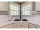 Kitchen sink with stainless steel basin, white countertops, and white cabinets at 7756 N Audubon Rd, Indianapolis, IN 46250