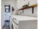 Bright laundry room with white appliances and open doorway to bathroom at 7756 N Audubon Rd, Indianapolis, IN 46250