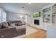 Cozy living room with fireplace, built-in shelving and a large sectional couch at 7756 N Audubon Rd, Indianapolis, IN 46250