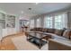 Inviting living room with hardwood floors, large sectional couch, and bar stool seating at 7756 N Audubon Rd, Indianapolis, IN 46250
