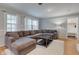 Spacious living room with hardwood floors, a sectional couch and a large window at 7756 N Audubon Rd, Indianapolis, IN 46250