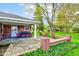 Covered stone patio with outdoor seating and a view of the expansive backyard at 7756 N Audubon Rd, Indianapolis, IN 46250