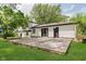 A spacious wood deck in a backyard with black trim and a large yard at 8041 Barry Rd, Indianapolis, IN 46219