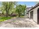 A sprawling wood deck in a backyard, framed by trees, a trampoline, and home exterior at 8041 Barry Rd, Indianapolis, IN 46219