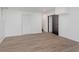 Neutral basement with wood-look floors, two closets, and black doorway at 8041 Barry Rd, Indianapolis, IN 46219