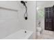 Clean bathroom with a bathtub, tiled walls, modern shower fixtures, and a vanity with stone countertop at 8041 Barry Rd, Indianapolis, IN 46219