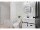 Stylish bathroom features a white vanity, round mirror, modern lighting, and a tub-shower combination at 8041 Barry Rd, Indianapolis, IN 46219