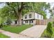 Angle view of home's exterior showcasing a long driveway, lush grass, and privacy fencing at 8041 Barry Rd, Indianapolis, IN 46219