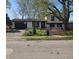 Charming home with a well-manicured lawn, mature trees, and an attached garage at 8041 Barry Rd, Indianapolis, IN 46219