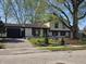 Inviting home featuring mature trees, manicured lawn, and an attached garage at 8041 Barry Rd, Indianapolis, IN 46219