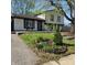 Charming two-story home with manicured lawn and a garden bed filled with flowers at 8041 Barry Rd, Indianapolis, IN 46219