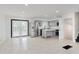 Modern kitchen with stainless steel appliances, gray cabinetry, and island with marble countertops at 8041 Barry Rd, Indianapolis, IN 46219