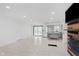 Open-concept living room featuring a modern kitchen, neutral paint, tile floors, and fireplace at 8041 Barry Rd, Indianapolis, IN 46219