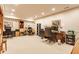 Spacious finished basement with multiple desks, chairs, and shelving units for versatile use at 902 N College Ave, Indianapolis, IN 46202