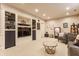 Carpeted basement room with recessed lighting, glass cabinets, and a comfortable seating area at 902 N College Ave, Indianapolis, IN 46202