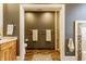 Bathroom with tile flooring, an open doorway, and a vanity to the side at 902 N College Ave, Indianapolis, IN 46202