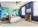 Vibrant bedroom features a world map wall, a ceiling fan, and ample natural light from a window at 902 N College Ave, Indianapolis, IN 46202
