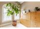 Bright bedroom featuring a large window, light colored walls and carpet, and a natural wood cabinet at 902 N College Ave, Indianapolis, IN 46202
