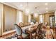 Elegant dining room with decorative lighting, seating for eight, and hardwood floors at 902 N College Ave, Indianapolis, IN 46202