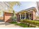 Brick home with a welcoming covered front porch, surrounded by greenery and mature trees at 902 N College Ave, Indianapolis, IN 46202