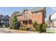 Charming brick home featuring a landscaped front yard and architectural details on a sunny day at 902 N College Ave, Indianapolis, IN 46202
