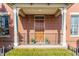 Cozy front porch with detailed railing, brick facade, and welcoming entrance at 902 N College Ave, Indianapolis, IN 46202