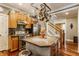 Open kitchen with custom cabinets, stainless steel appliances, island with seating, and staircase view at 902 N College Ave, Indianapolis, IN 46202