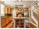 Beautiful kitchen with an island, stainless appliances, and open access to a staircase at 902 N College Ave, Indianapolis, IN 46202