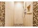 Modern shower with a pebble floor, stone walls, and a built-in niche for toiletries at 902 N College Ave, Indianapolis, IN 46202