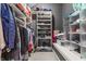 Walk-in closet with custom shelving and hanging space for organized storage at 902 N College Ave, Indianapolis, IN 46202