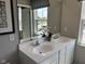 Bathroom featuring a double vanity, framed mirror, and decorative plants at 990 Sunchaser Rd, Lebanon, IN 46052