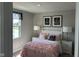 Charming bedroom with pink accents, bedside tables, and natural light from the window at 990 Sunchaser Rd, Lebanon, IN 46052