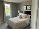 Bright bedroom featuring a plush white bed with decorative pillows and natural light from the window at 990 Sunchaser Rd, Lebanon, IN 46052