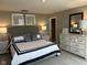 Comfortable bedroom featuring a decorative bed, dresser, and framed artwork at 990 Sunchaser Rd, Lebanon, IN 46052