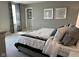Bright bedroom with patterned curtains and black and white bedding accents at 990 Sunchaser Rd, Lebanon, IN 46052