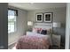 Cozy bedroom featuring a stylish pink ruffle bedspread, decorative pillows, and two chandelier-themed artworks at 990 Sunchaser Rd, Lebanon, IN 46052