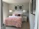 Charming bedroom featuring a pink, ruffled comforter, chandelier art, and bedside lamps at 990 Sunchaser Rd, Lebanon, IN 46052