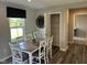 Inviting dining area with a large table, stylish chairs, and access to a pantry at 990 Sunchaser Rd, Lebanon, IN 46052