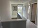 Bright hallway leads to bedrooms and a stairway with carpeted steps at 990 Sunchaser Rd, Lebanon, IN 46052