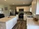 Bright kitchen boasts white cabinets, stainless steel appliances, and island for meal prep at 990 Sunchaser Rd, Lebanon, IN 46052